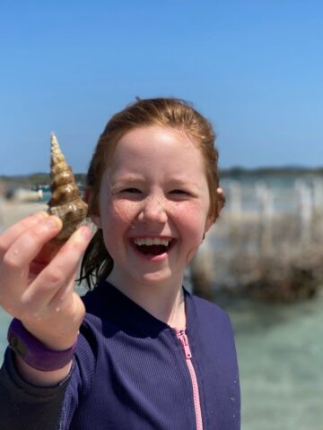 Our 5 favourite Australian holiday spots with kids girl with shell at beach